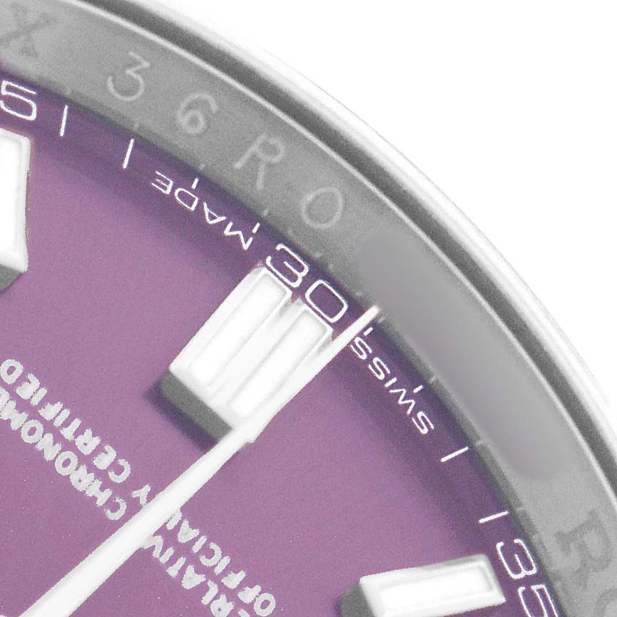 The image shows a close-up of the Rolex Oyster Perpetual 116000 Men's Stainless Steel Purple Dial watch face, highlighting the hour markers and edge of the dial.