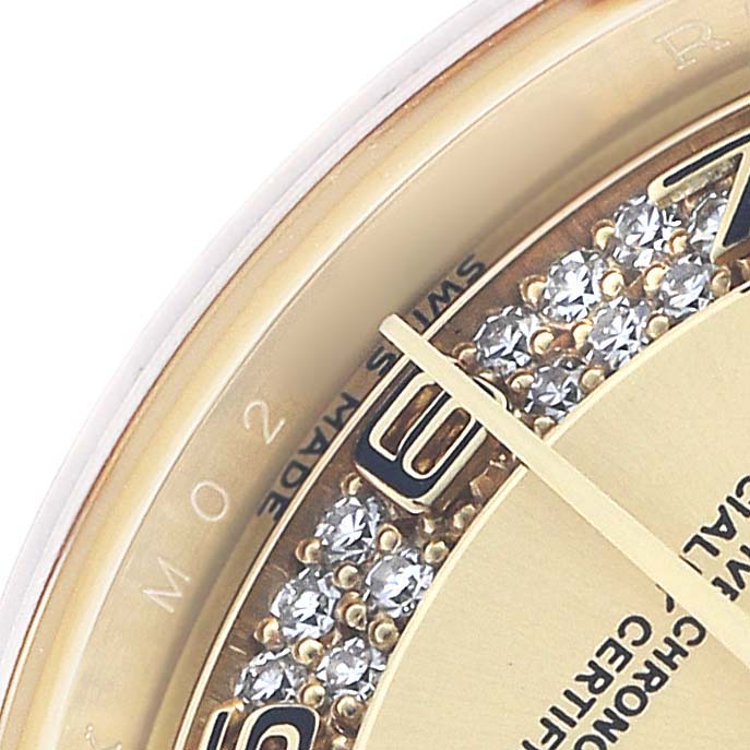 This close-up shows the dial and part of the bezel of a Rolex President 179178 Women's Yellow Gold Champagne Dial watch, highlighting its gold elements and diamond details.