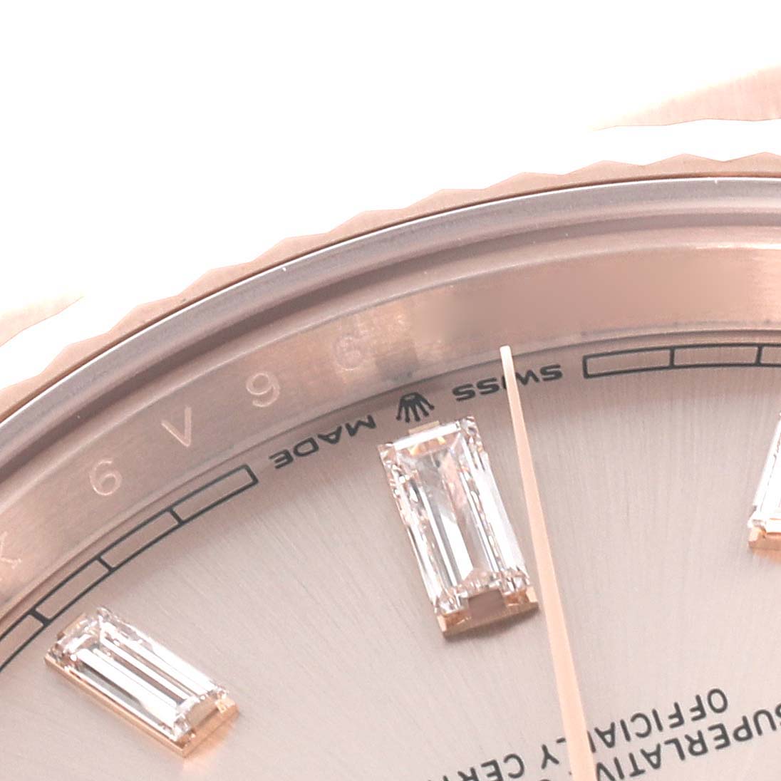 This close-up shows the bezel, dial, and hour markers of the Rolex President 228235-004 Men's Rose Gold Silver Dial 228235-004 Men's Rose Gold Silver Dial model.