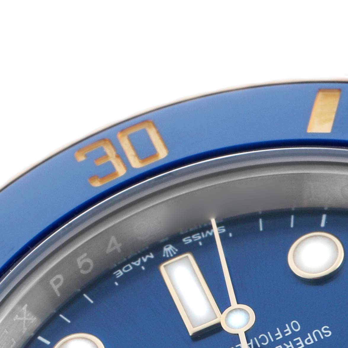 The image shows a close-up of the Rolex Submariner 126613 Men's Steel and Gold (two tone) Blue Dial's blue bezel and part of the dial, including hour markers and "30" on the bezel.