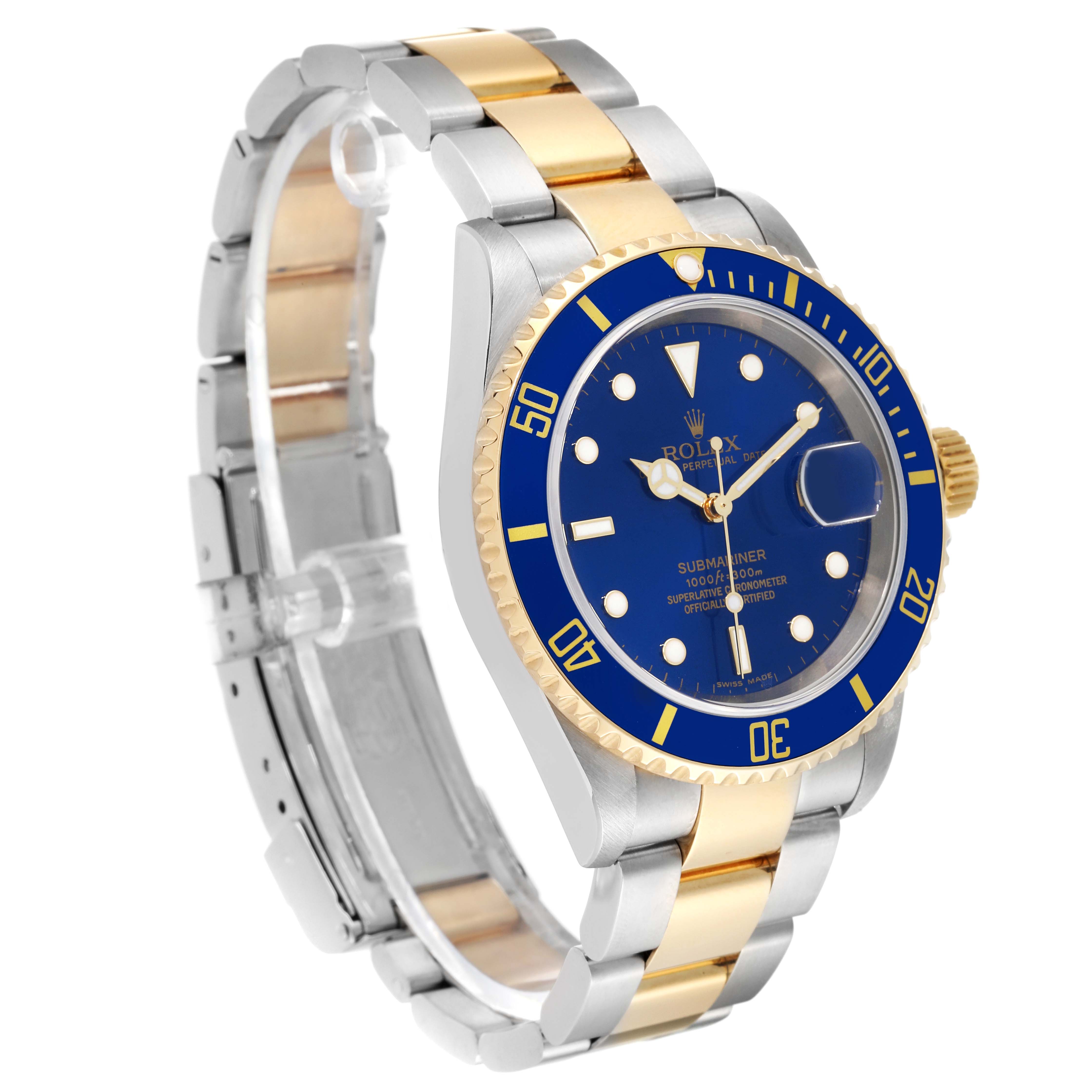 The image shows a Rolex Submariner 16613 Men's Steel and Gold (two tone) Blue Dial 16613 Men's Steel and Gold (two tone) Blue Dial watch at a three-quarter angle, highlighting its blue dial and two-tone bracelet.