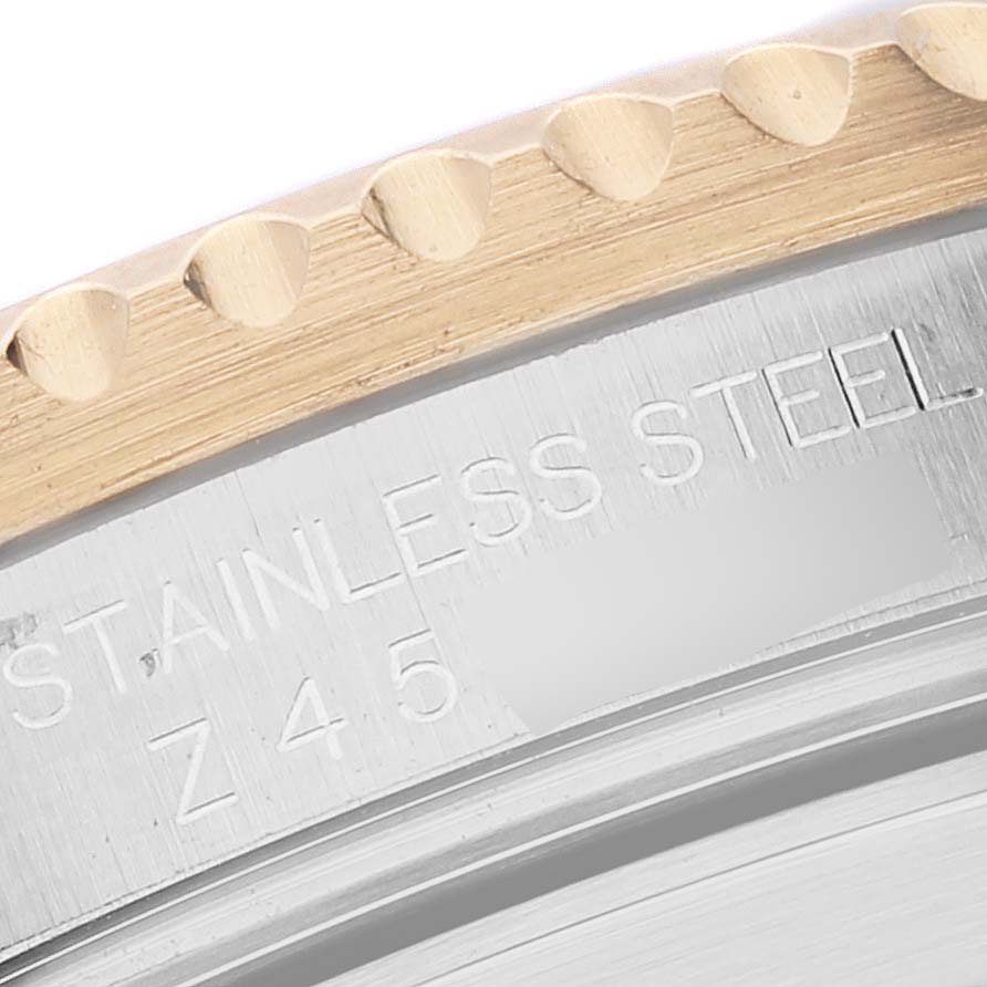 The image shows a close-up angle of the bezel and part of the case with markings for the Rolex Submariner 16613 Men's Steel and Gold (two tone) Blue Dial 16613 Men's Steel and Gold (two tone) Blue Dial model, indicating "STAINLESS STEEL."