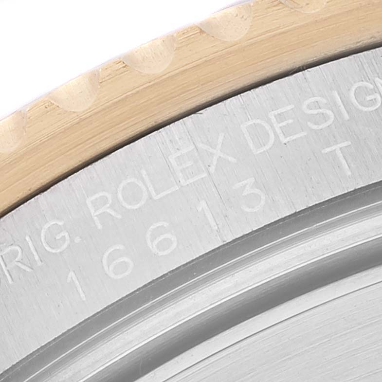 This close-up image shows part of the bezel and the engraved model number "16613" on the case back of a Rolex Submariner 16613 Men's Steel and Gold (two tone) Blue Dial 16613 Men's Steel and Gold (two tone) Blue Dial.