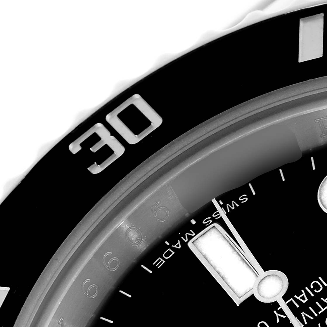 The image shows a close-up of the bezel and dial of a Rolex Submariner 116610 Men
s Stainless Steel Black Dial 116610 Men
s Stainless Steel Black Dial, focusing on the 30-minute mark.