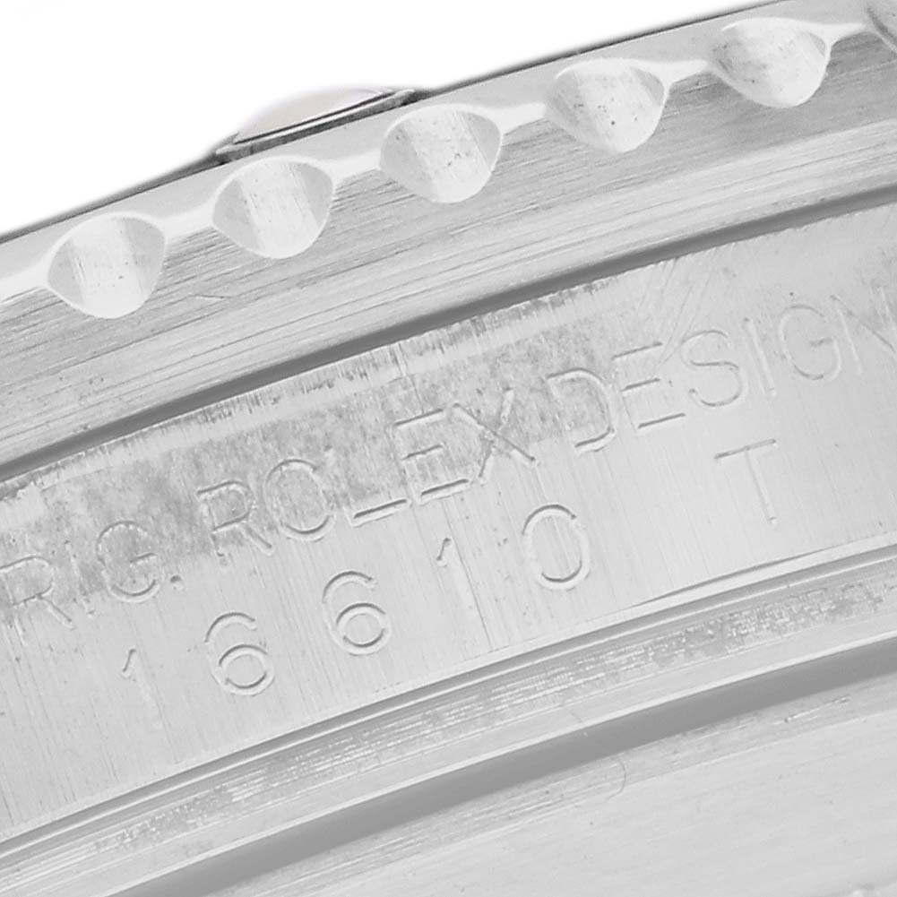 The image shows a close-up side view of the bezel and engraved details on a Rolex Submariner 16610 Men's Stainless Steel Black Dial watch.