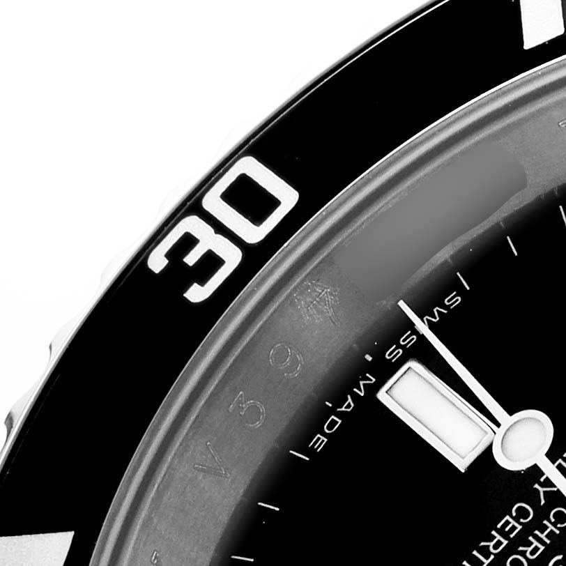 The image shows a close-up of the bezel and part of the dial with hour markings of a Rolex Submariner 16610 Men's Stainless Steel Black Dial.