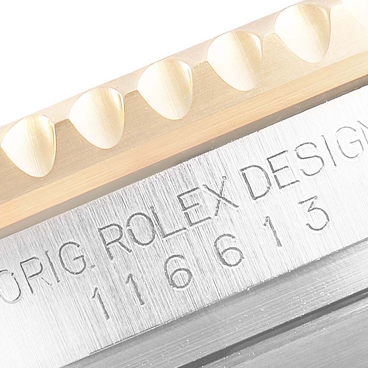 This close-up image shows the bezel and engravings of a Rolex Submariner 116613 Men's Steel and Gold (two tone) Black Dial 116613 Men's Steel and Gold (two tone) Black Dial watch.