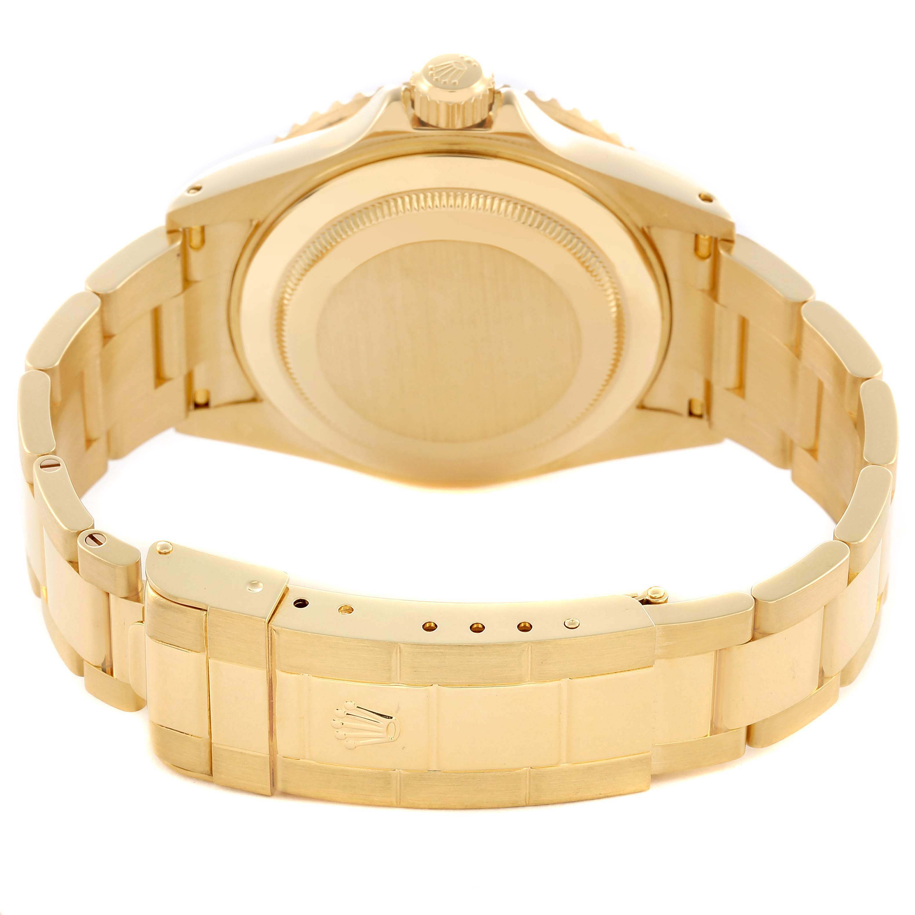 The image shows the back view of a gold Rolex Submariner 16618 Men's Yellow Gold Blue Dial 16618 Men's Yellow Gold Blue Dial, highlighting the case back and bracelet clasp.