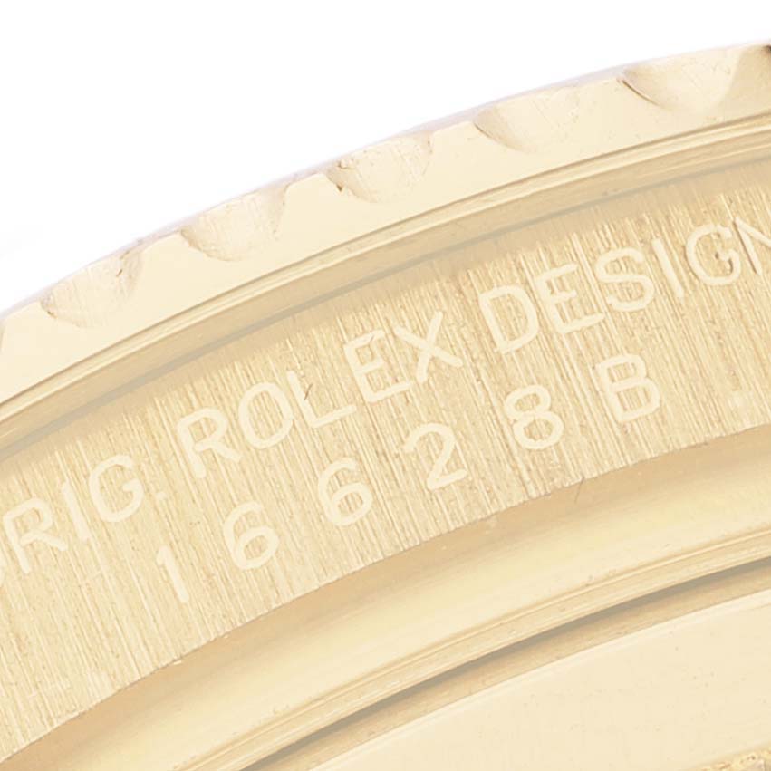 The image shows a close-up of the side casing and bezel of a Rolex Yacht-Master 16628 Men's Yellow Gold Blue Dial 16628 Men's Yellow Gold Blue Dial.