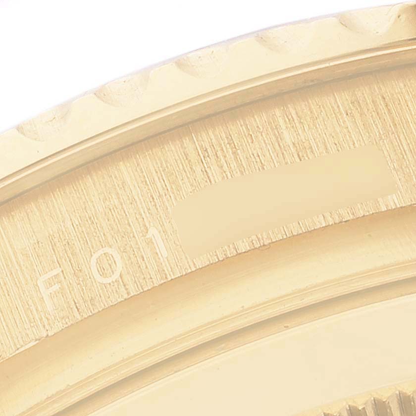 This close-up image shows a partial view of the bezel and the serial number area on the Rolex Yacht-Master 16628 Men's Yellow Gold Blue Dial 16628 Men's Yellow Gold Blue Dial watch.