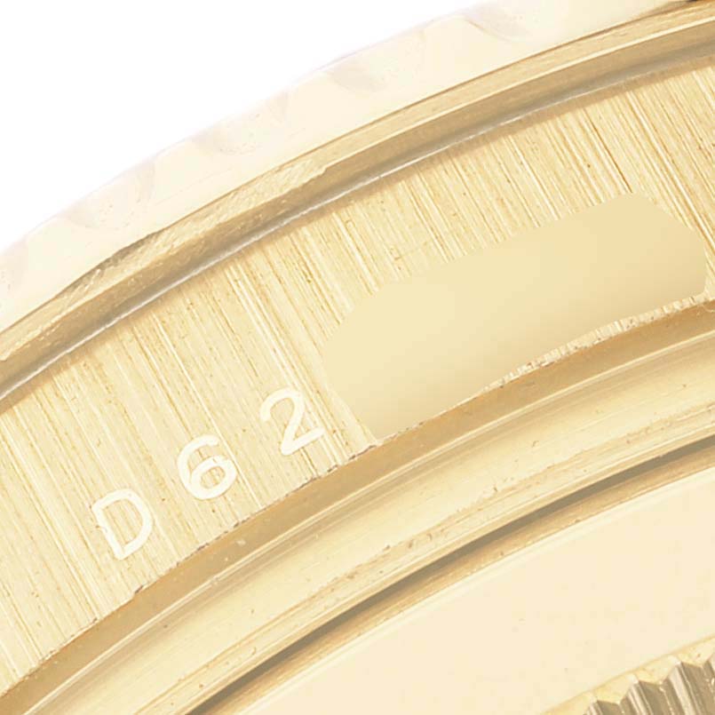 This close-up image shows part of the flange and bezel of a Rolex Yacht-Master 16628 Men's Yellow Gold White Dial 16628 Men's Yellow Gold White Dial watch.