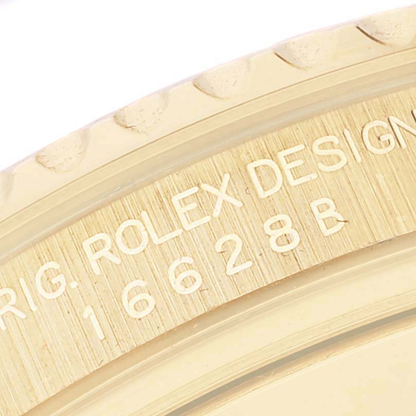 The image shows a close-up of the engraved model number and serial details on the bezel of a Rolex Yacht-Master 16628 Men's Yellow Gold White Dial 16628 Men's Yellow Gold White Dial watch.
