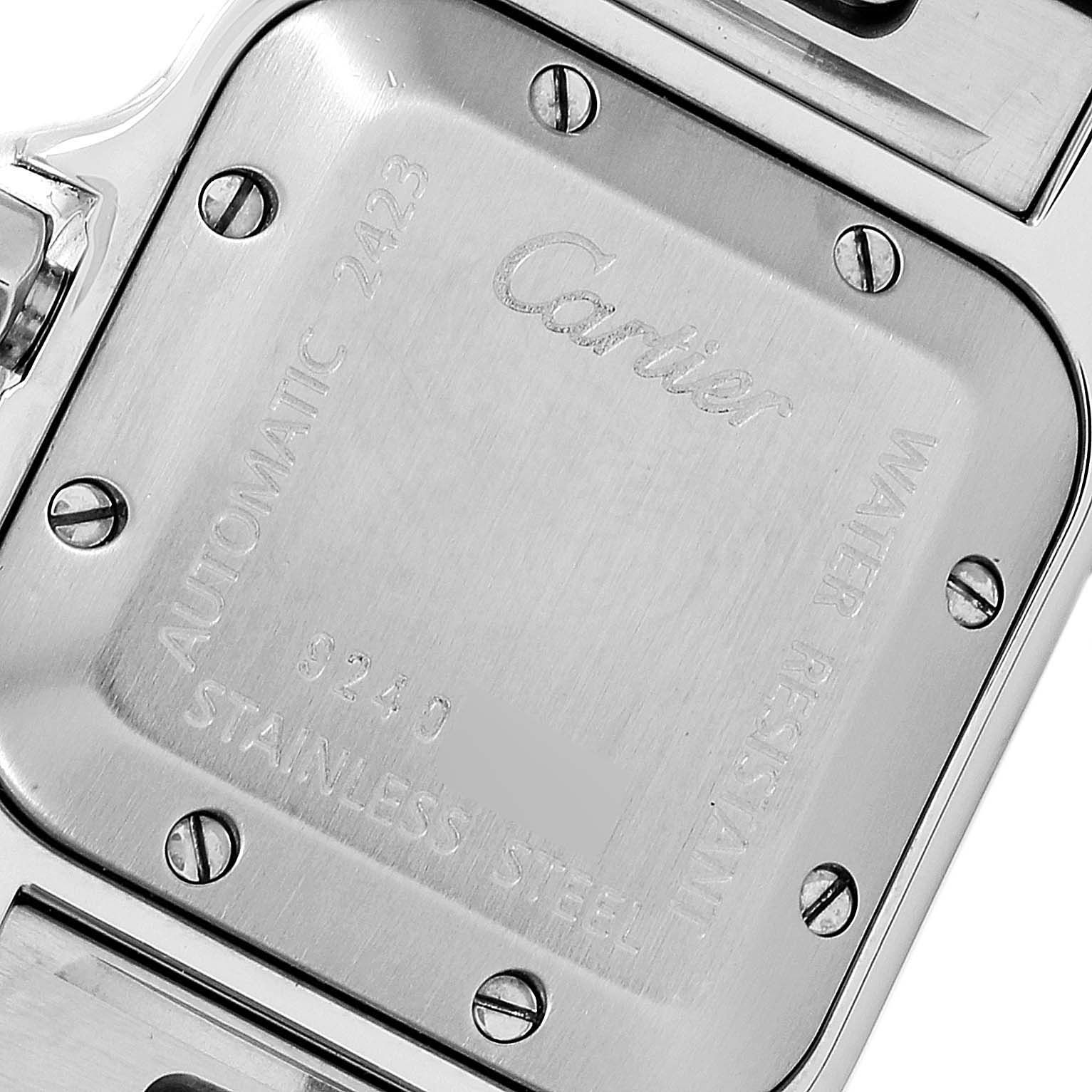 The image shows the back case of a Santos model by Cartier, highlighting its stainless-steel finish and engravings.