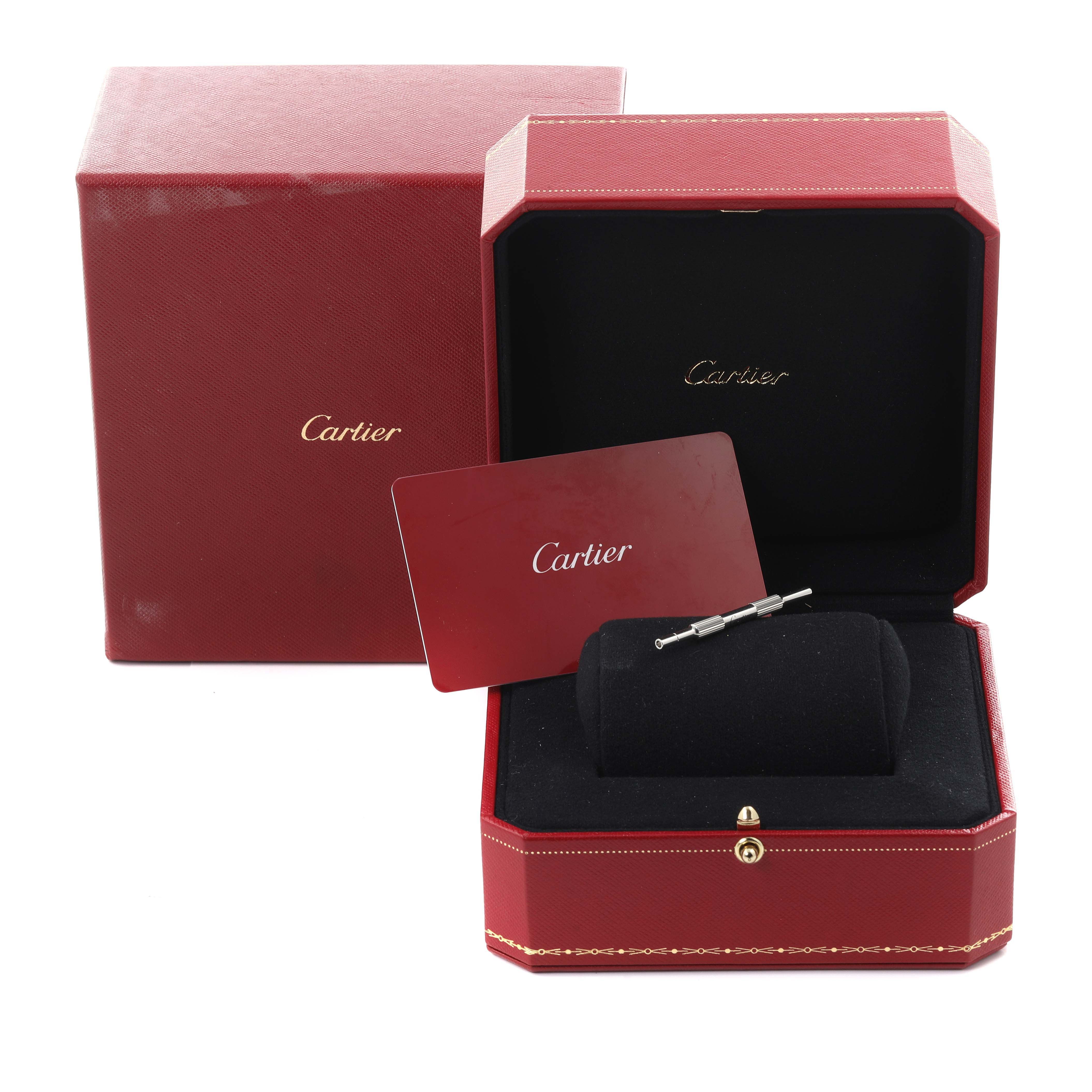 The Cartier Santos W2SA0016 Men's Steel and Gold (two tone) Silver Dial W2SA0016 Men's Steel and Gold (two tone) Silver Dial watch box is open, showing packaging, a card, and small watch accessories.