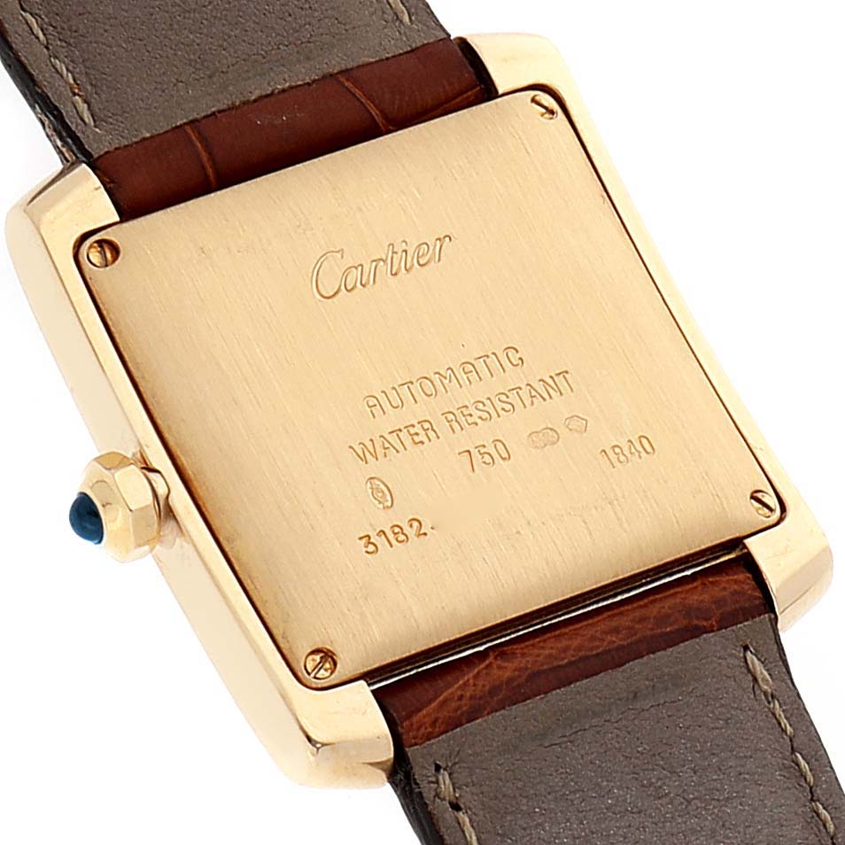 The image shows the back view of a Cartier Tank Francaise W5000156 Men's Yellow Gold Silver Dial W5000156 Men's Yellow Gold Silver Dial watch, highlighting the case back and leather strap.