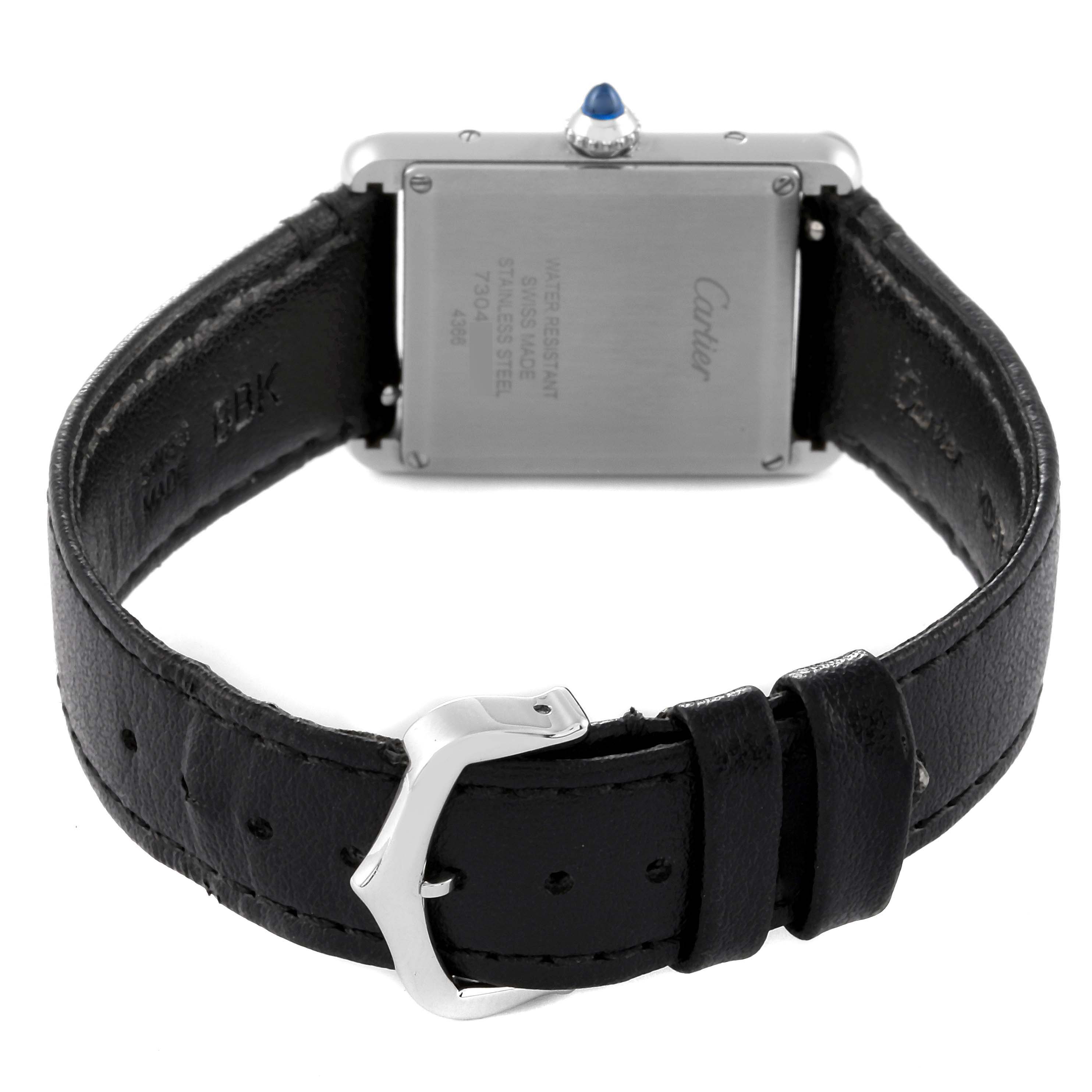 The image shows the back and leather strap of a Cartier Tank Must WSTA0059 Men's Stainless Steel Silver Dial WSTA0059 Men's Stainless Steel Silver Dial watch, highlighting the buckle and case back.