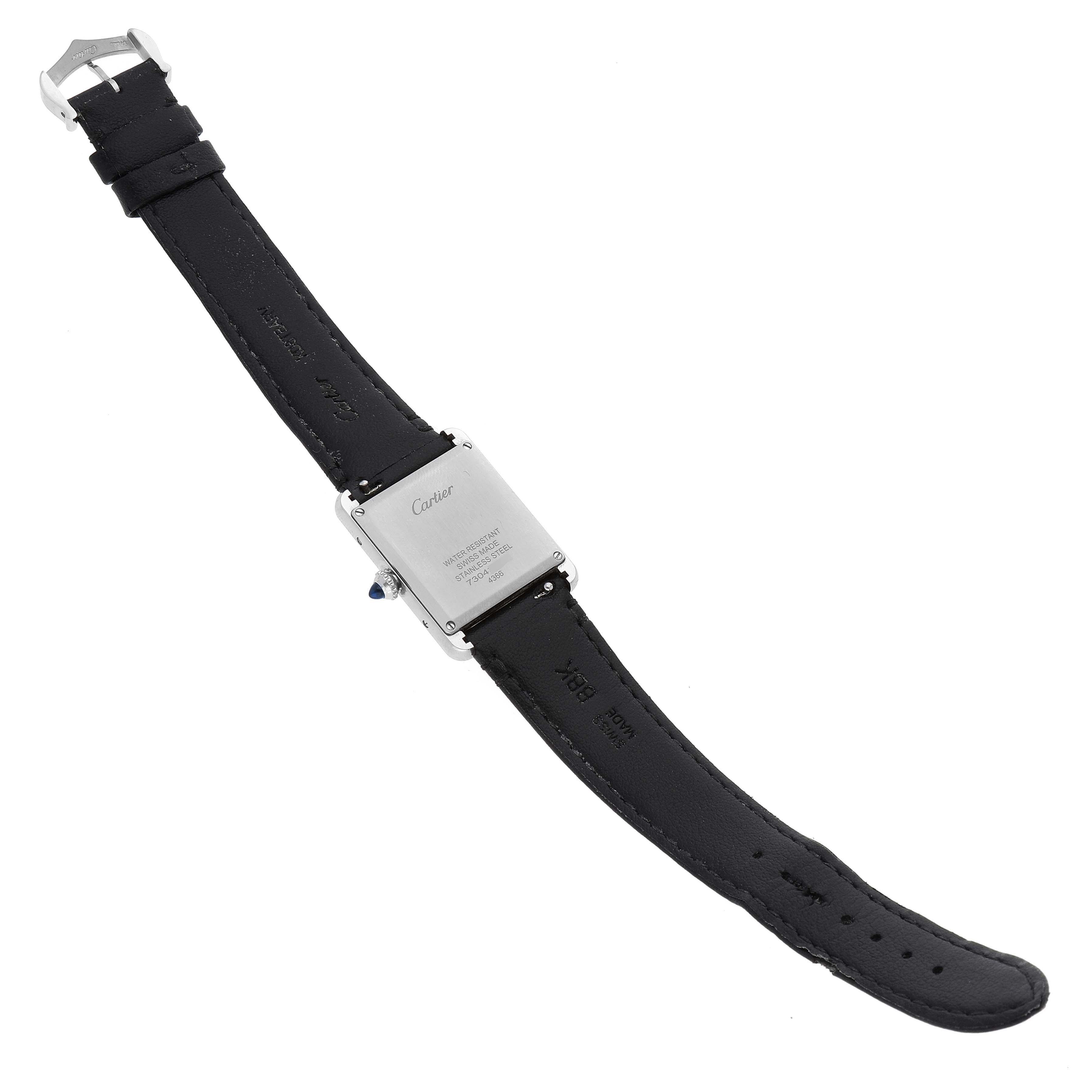 The image shows the back view of a Cartier Tank Must WSTA0059 Men's Stainless Steel Silver Dial WSTA0059 Men's Stainless Steel Silver Dial watch, displaying the case back and leather strap.