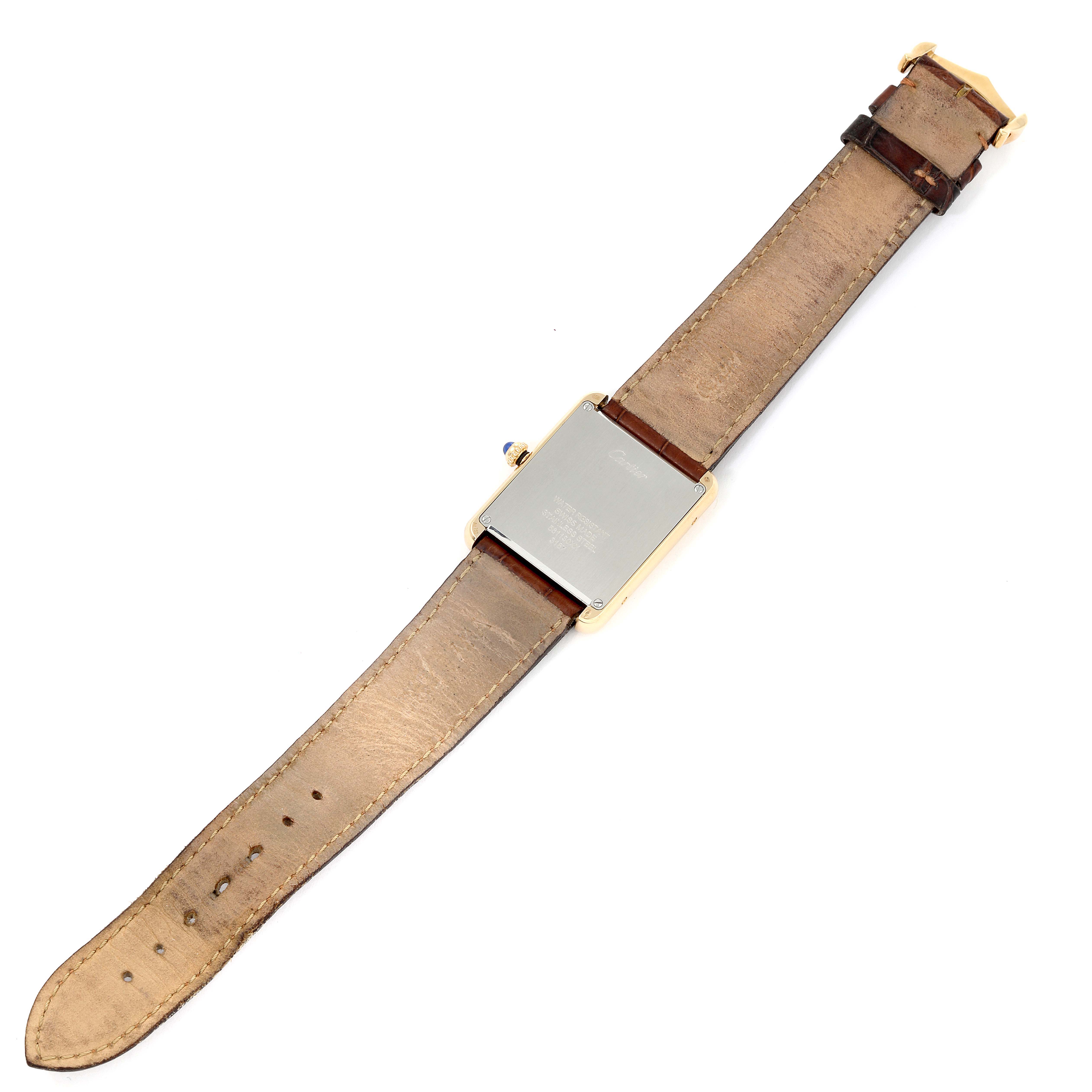 The image shows the back view of a Cartier Tank Solo W5200004 Men's Yellow Gold Silver Dial W5200004 Men's Yellow Gold Silver Dial watch with its leather strap fully extended.