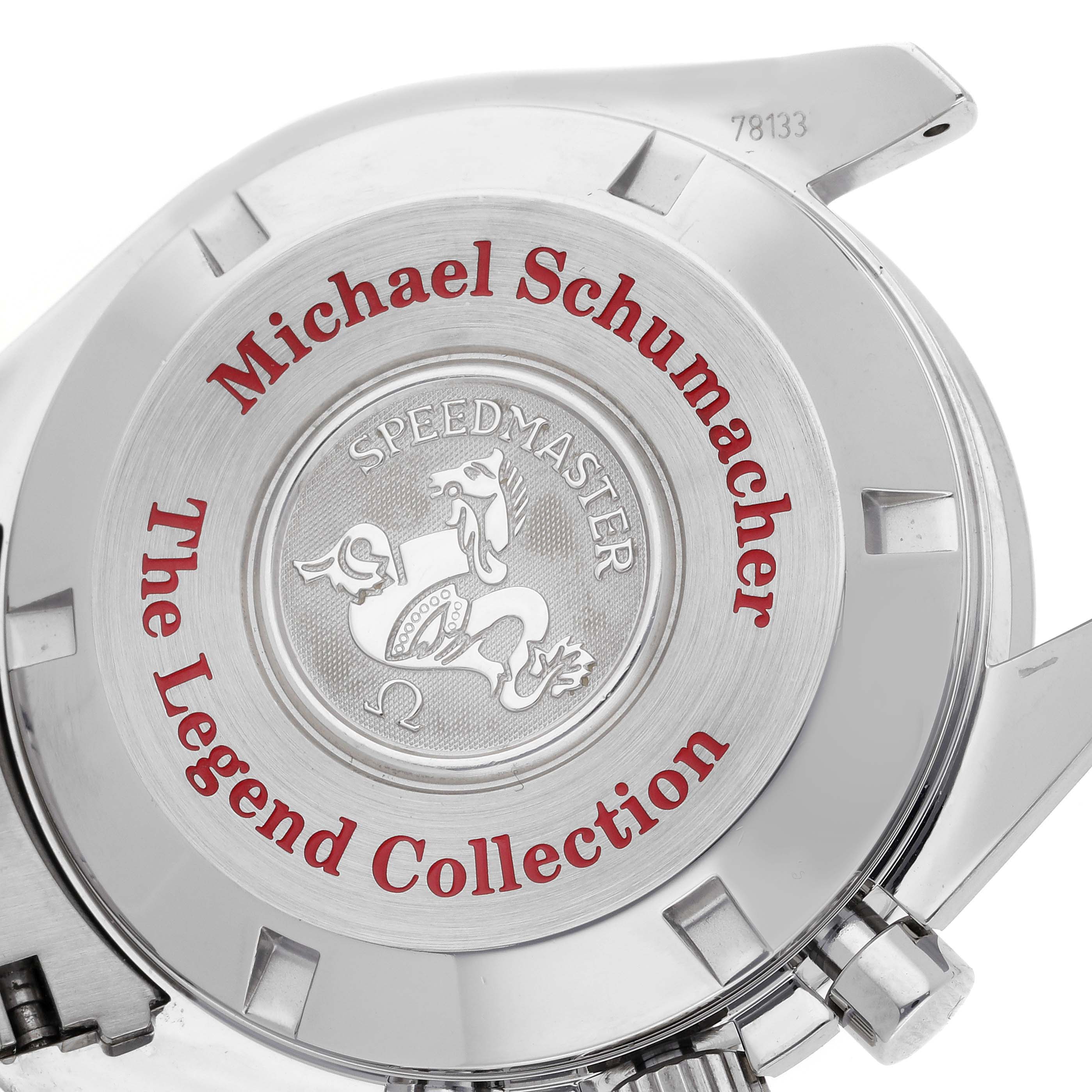 The image shows the back of an Omega Speedmaster 3506.61.00 Men
s Stainless Steel Red Dial 3506.61.00 Men
s Stainless Steel Red Dial watch featuring the "Michael Schumacher The Legend Collection" engraving.
