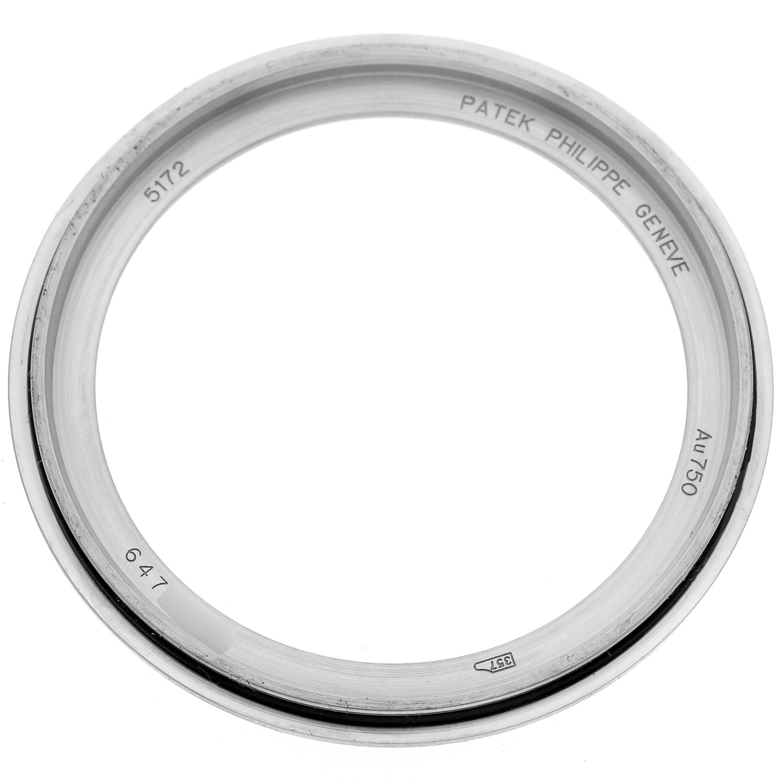 The image shows a bezel of the Patek Philippe Complications 5172G-001 Men's White Gold Blue Dial 5172G-001 Men's White Gold Blue Dial model, viewed from above with engraved details.