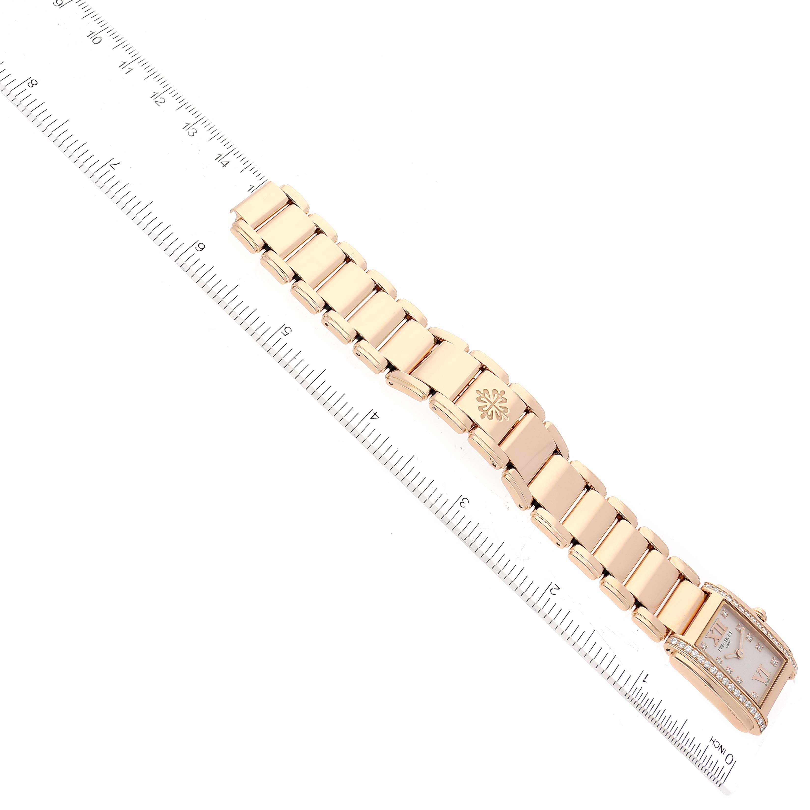 The image shows a Patek Philippe Twenty-4 4908/11R Women's Rose Gold Silver Dial 4908/11R Women's Rose Gold Silver Dial model watch laid flat with its bracelet fully extended and a ruler beside it for scale.