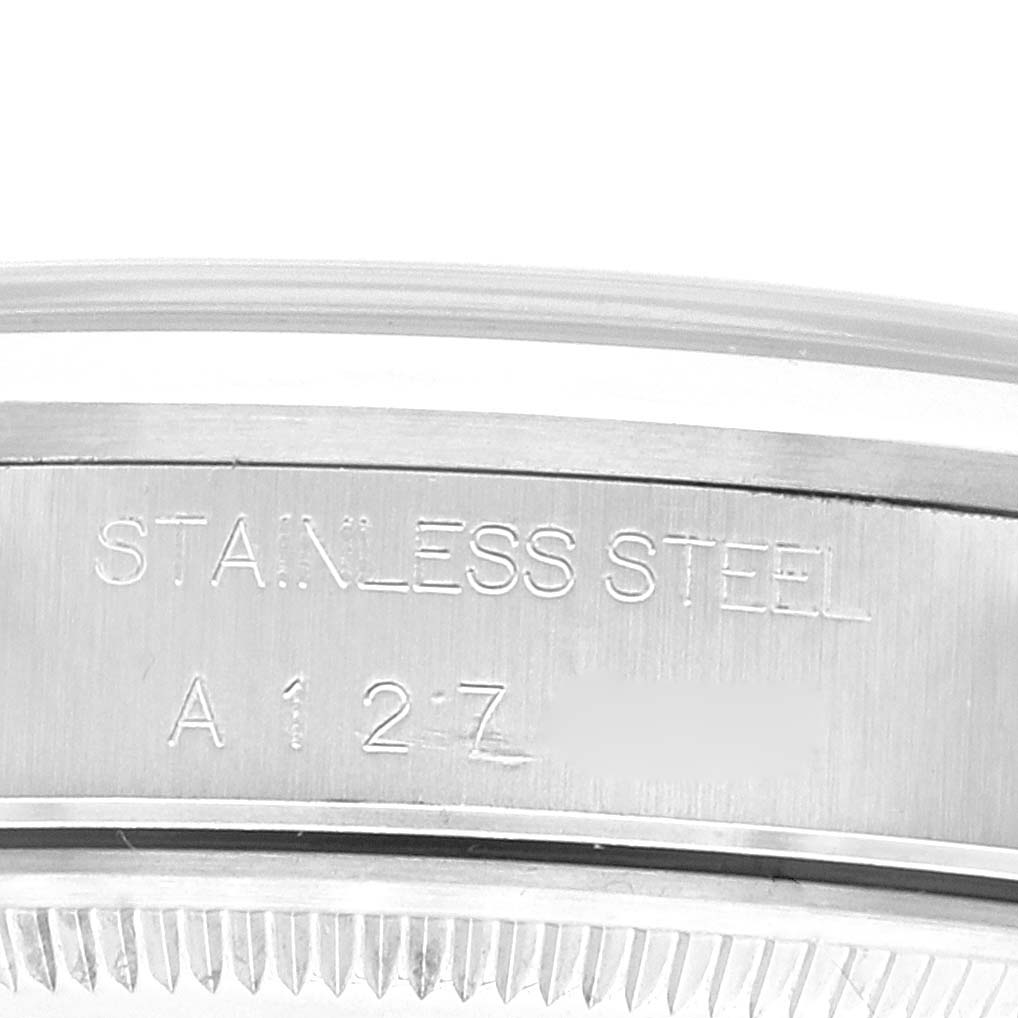 This image shows a close-up of the case back edge of a Rolex Air-King 14000 Men's Stainless Steel Blue Dial 14000 Men's Stainless Steel Blue Dial watch, highlighting the "STAINLESS STEEL" engraving.