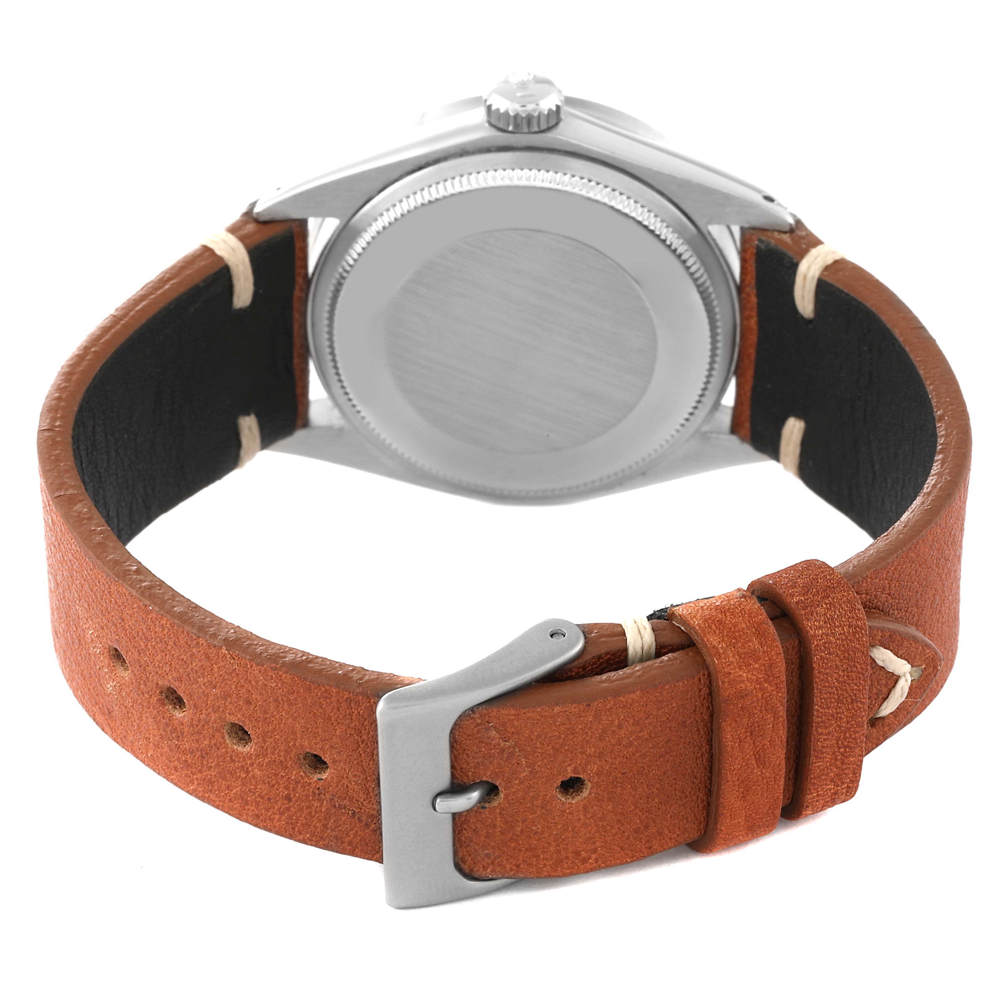 This image shows the back of a Rolex Date 1501 Men's Stainless Steel Black Dial 1501 Men's Stainless Steel Black Dial model with a brown leather strap and silver buckle.