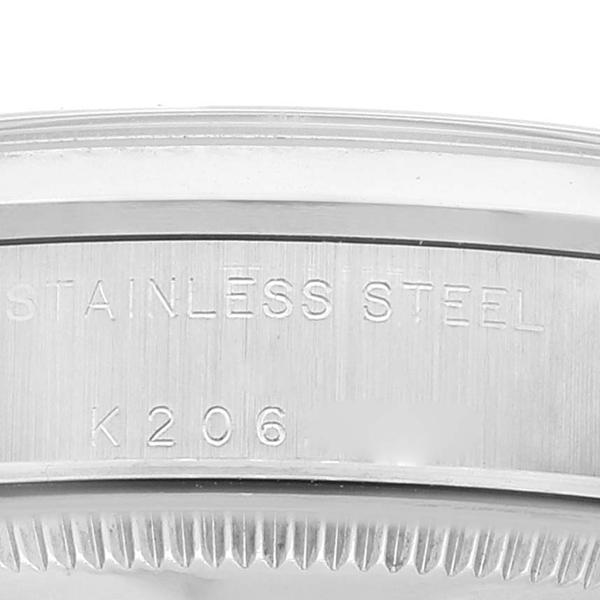 The image shows a close-up angle of the side and bezel of a Rolex Mid-Size 78240 Women
s Stainless Steel Silver Dial 78240 Women
s Stainless Steel Silver Dial model, highlighting the stainless steel marking and serial number.