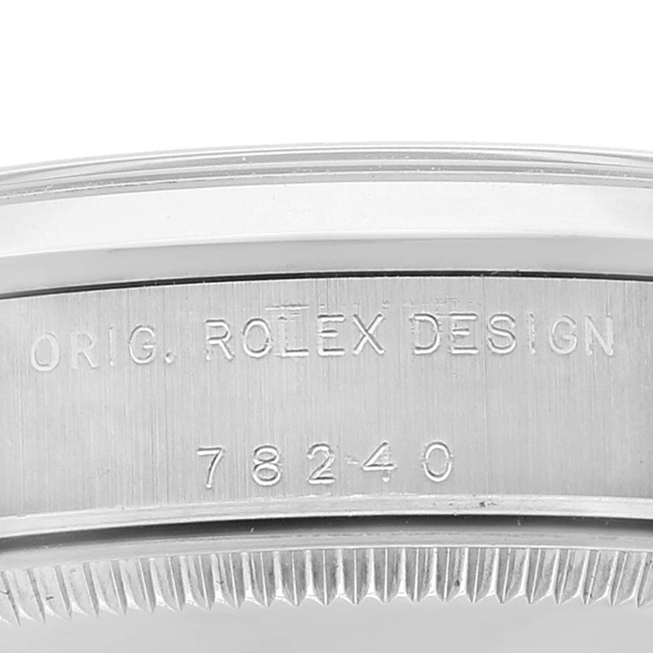 The image shows a close-up of the side of a Rolex Mid-Size 78240 Women
s Stainless Steel Silver Dial 78240 Women
s Stainless Steel Silver Dial model, focusing on the engraved "ORIG. ROLEX DESIGN" and the model number "78240".