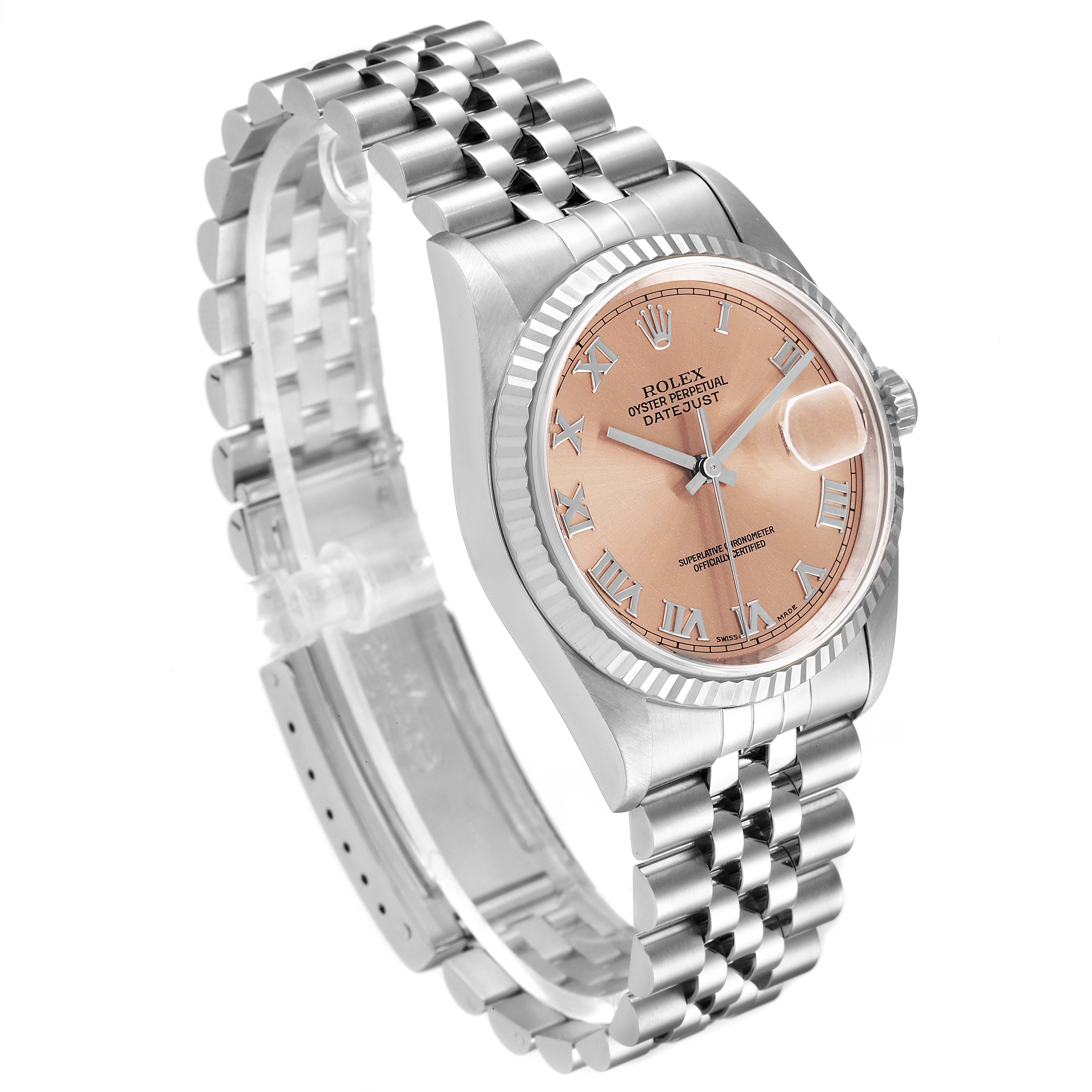 The Rolex Datejust 16234 Men
s Stainless Steel Pink Dial 16234 Men
s Stainless Steel Pink Dial watch is shown at a diagonal angle, displaying its dial, fluted bezel, jubilee bracelet, and Rolex crown logo.