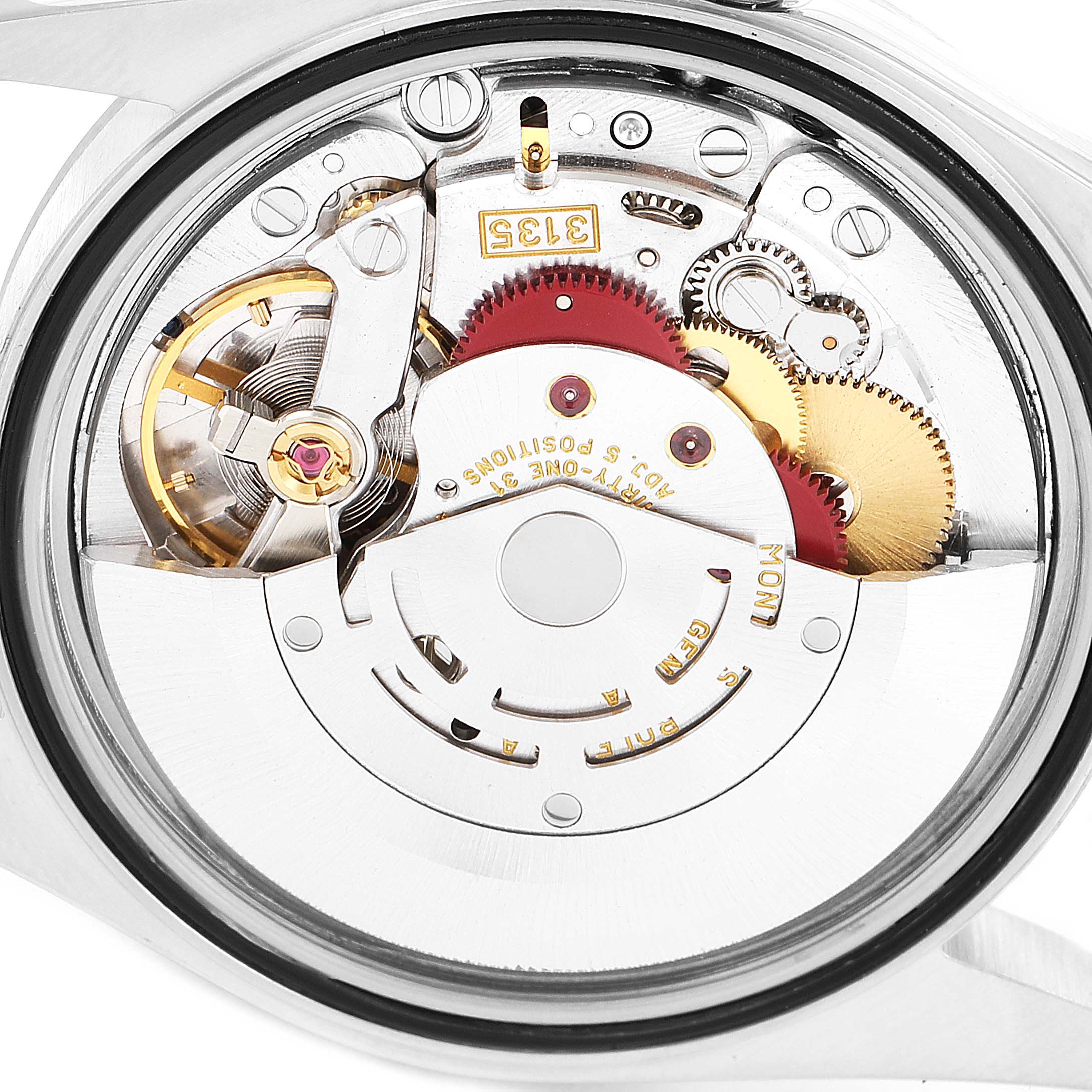 The image shows the internal mechanism of a Rolex Datejust 16234 Men
s Stainless Steel Pink Dial 16234 Men
s Stainless Steel Pink Dial watch from a back angle, highlighting its intricate gears and movement.