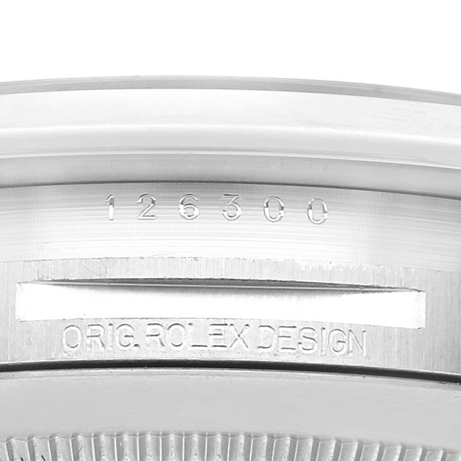 This close-up image of the Rolex Datejust 41 126300 Men's Stainless Steel Grey Dial 126300 Men's Stainless Steel Grey Dial shows the model number and "ORIG ROLEX DESIGN" engraving on the case.