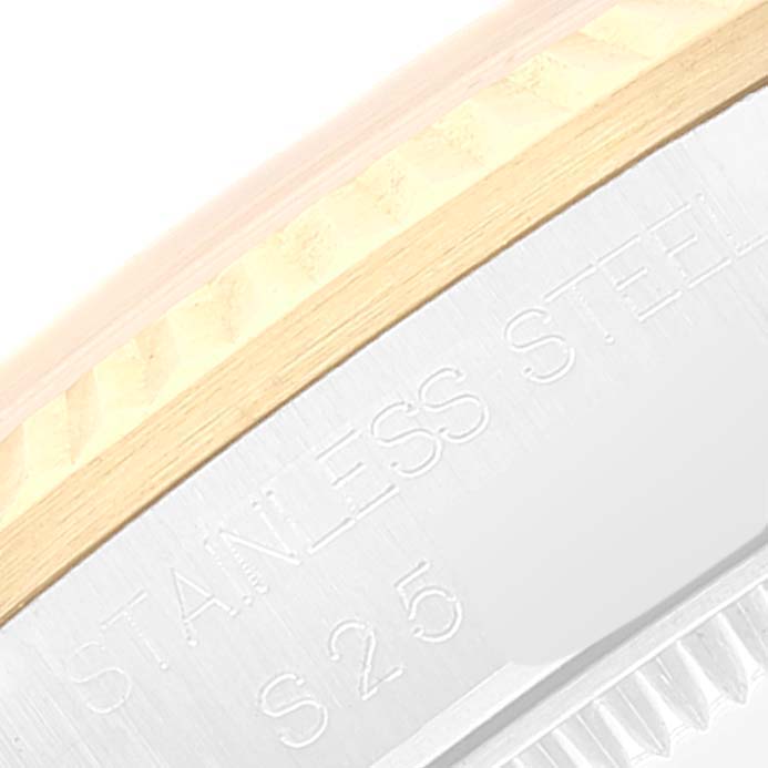 This image shows a close-up of the bezel and part of the case back of a Mid-Size Rolex watch, highlighting the "STAINLESS STEEL" engraving.