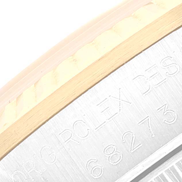 The image shows a close-up of the bezel and engraved side of a Mid-Size Rolex watch.