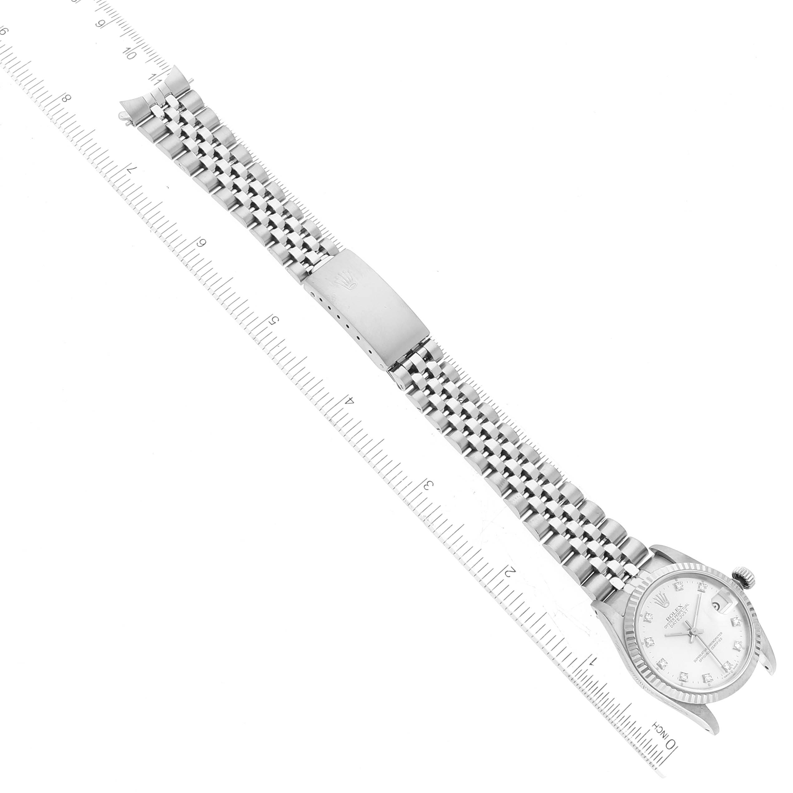 The Rolex Mid-Size 68274 Women's Stainless Steel Silver Dial 68274 Women's Stainless Steel Silver Dial watch is shown from a top-down angle, displaying the face, bracelet, and clasp with a ruler for scale.