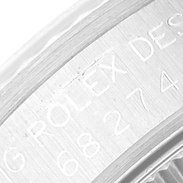 This image shows a close-up of the engraved serial number on the inner bezel of a Rolex Mid-Size 68274 Women's Stainless Steel Silver Dial 68274 Women's Stainless Steel Silver Dial watch.