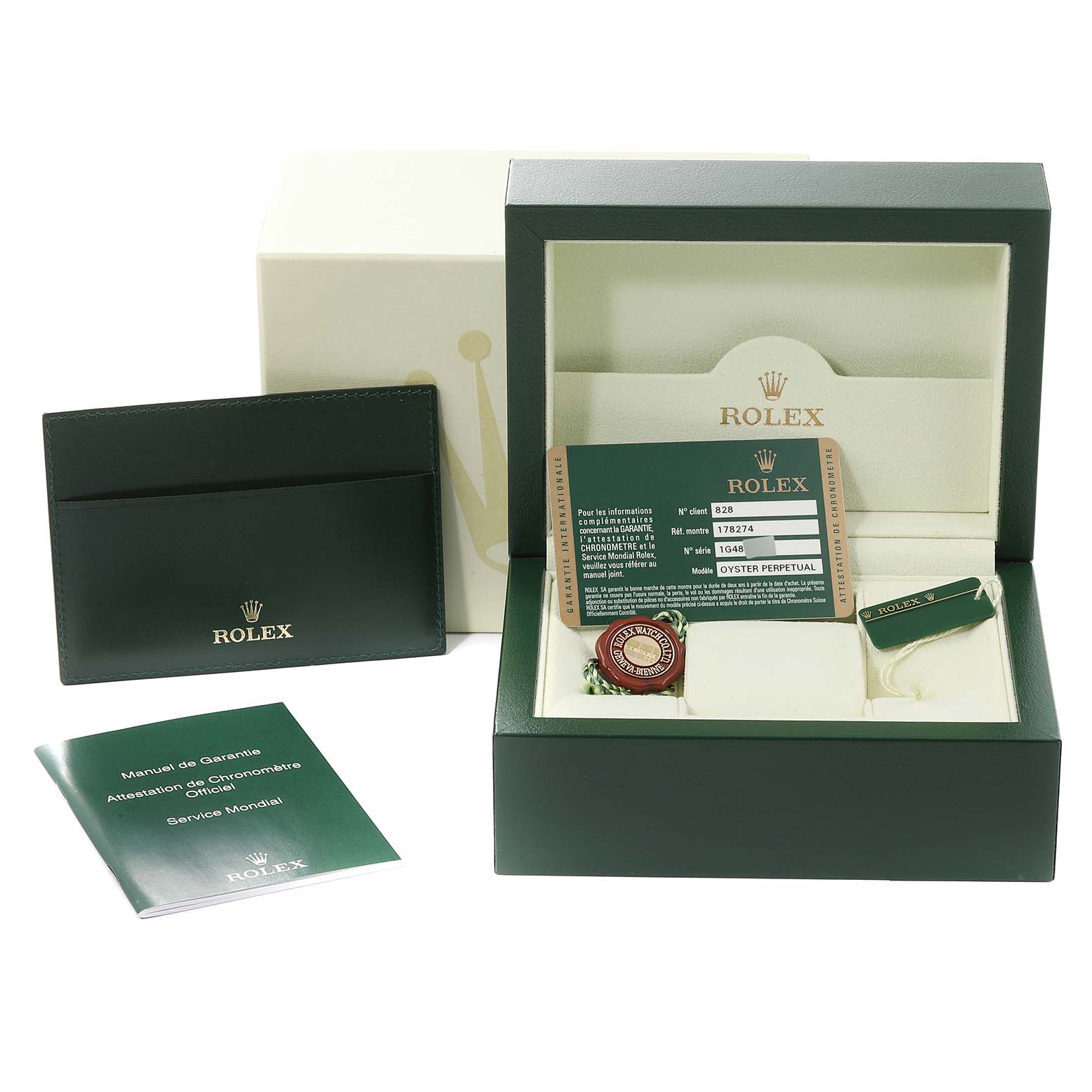 The image shows a Rolex Mid-Size 178274 Women
s Stainless Steel Black Dial 178274 Women
s Stainless Steel Black Dial watch packaging, including the box, warranty manual, card holder, and tags, viewed from the front.