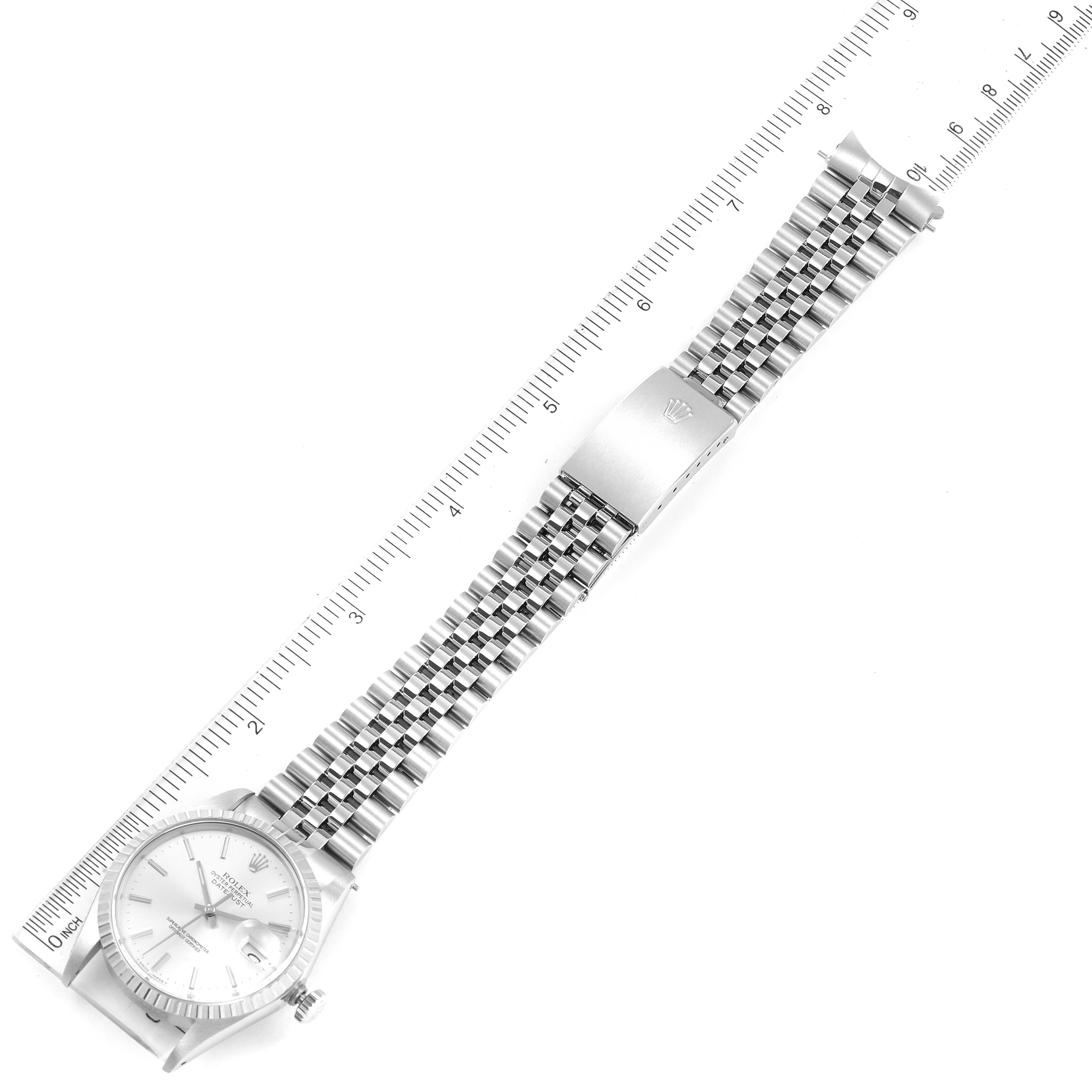 The Vintage Collection Rolex watch is shown from a top-down angle, displaying the face, bracelet, and clasp next to a ruler.
