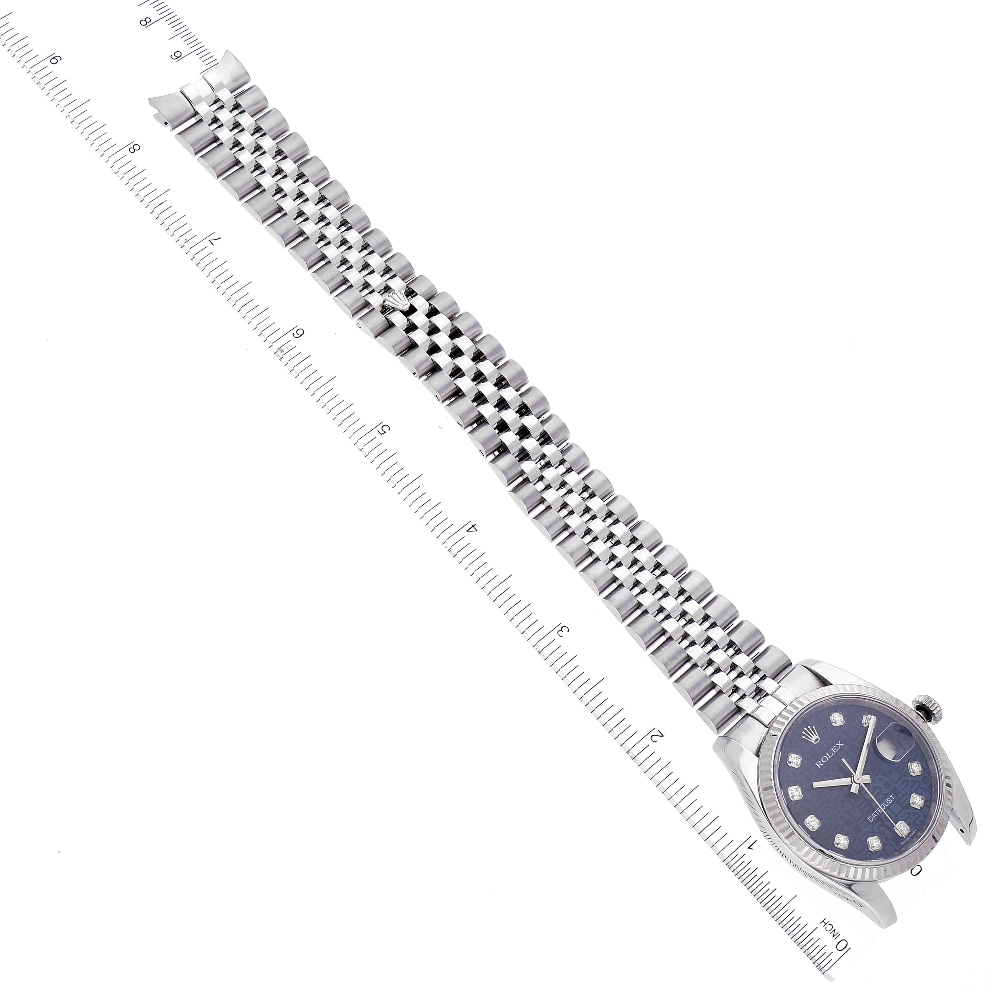 The image shows a top view of a Rolex Datejust 116234 Men's Stainless Steel Blue Dial 116234 Men's Stainless Steel Blue Dial watch, displaying its face and metal bracelet alongside a ruler for scale.