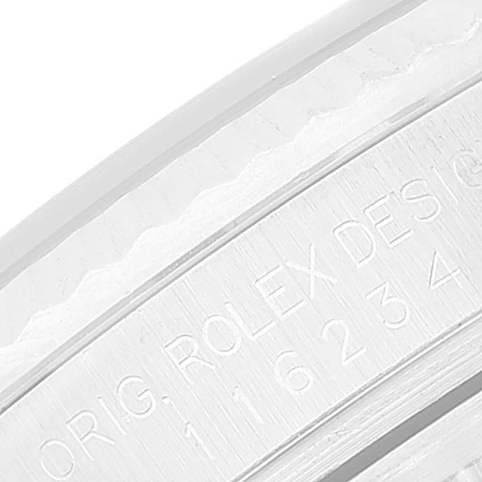 This close-up image shows the engraved text on the inner bezel of a Rolex Datejust 116234 Men's Stainless Steel Blue Dial 116234 Men's Stainless Steel Blue Dial watch.