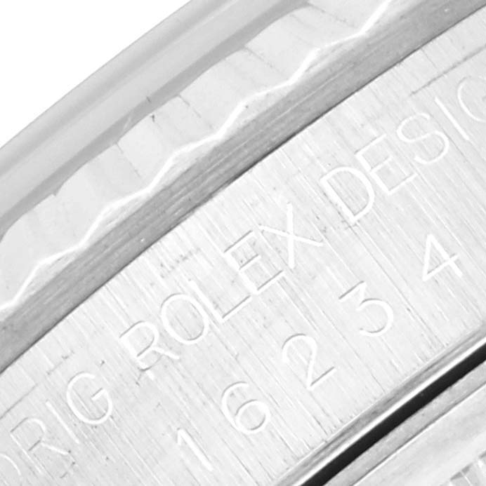 The image shows a close-up of the engravings on the case of a Rolex Datejust 16234 Men's Stainless Steel Silver Dial 16234 Men's Stainless Steel Silver Dial watch.