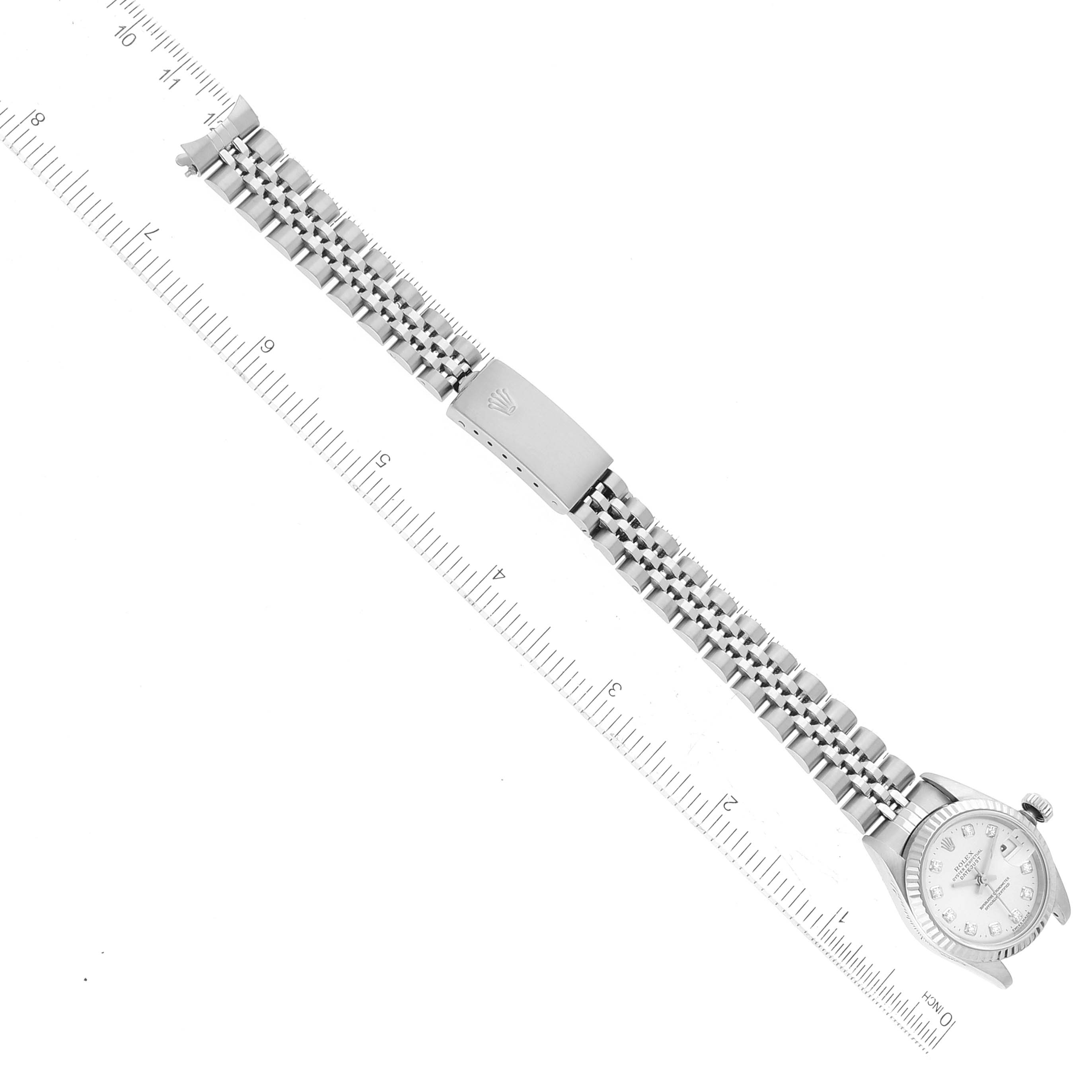 This image shows a Rolex Datejust 69174 Women's Stainless Steel Silver Dial 69174 Women's Stainless Steel Silver Dial watch laid flat with the dial, bracelet, and clasp visible, alongside a ruler for scale.