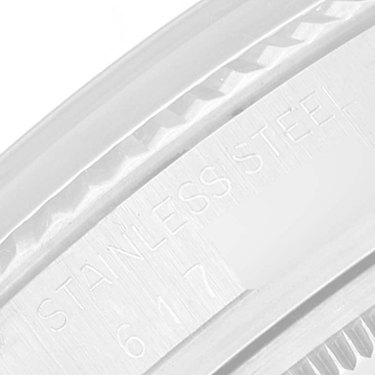 The image shows a close-up of the bezel and part of the case back of a Vintage Collection model by Rolex, with "STAINLESS STEEL" engraved.