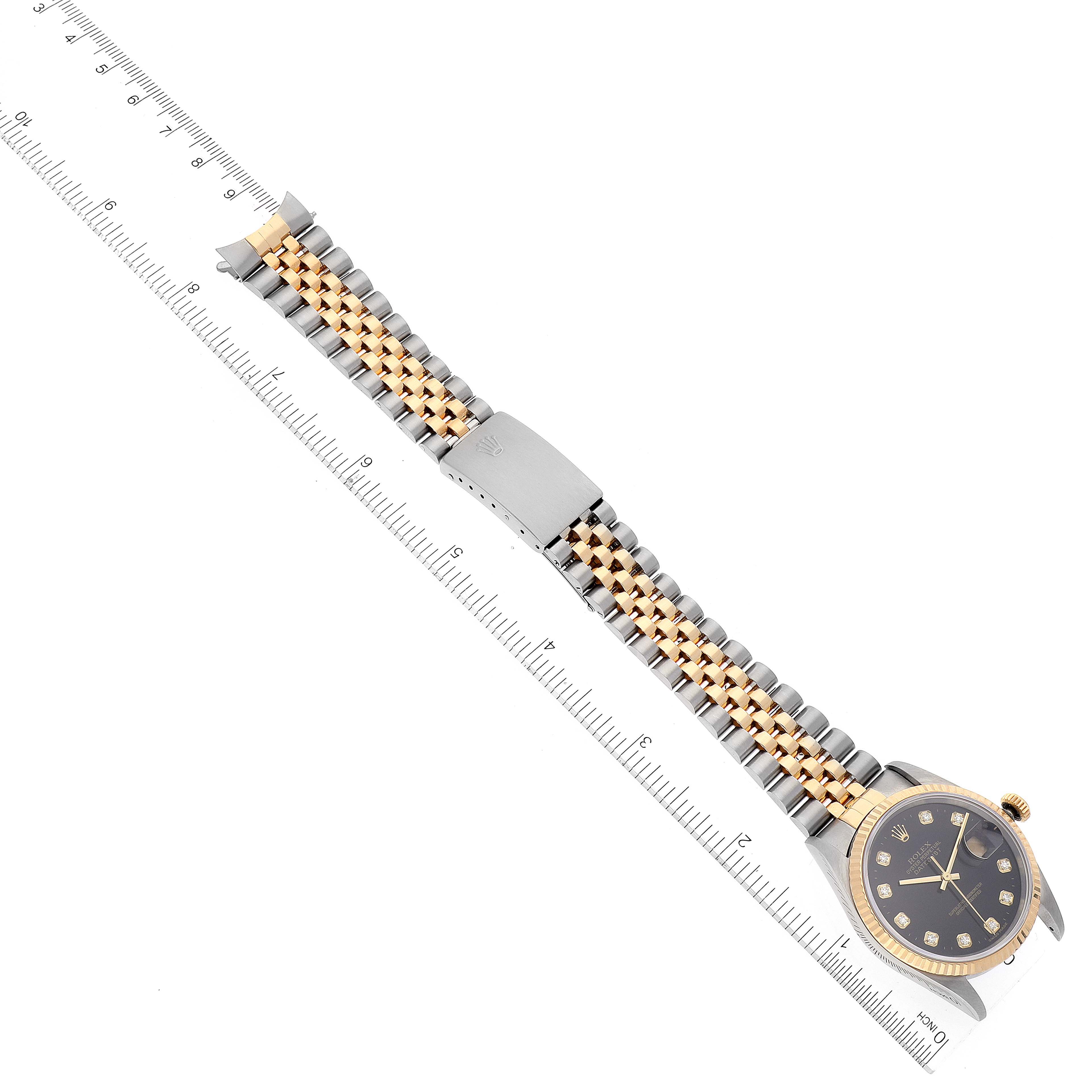 This image shows a Rolex Datejust 16233 Men's Steel and Gold (two tone) Black Dial 16233 Men's Steel and Gold (two tone) Black Dial watch from an overhead angle with its face, bezel, bracelet, and clasp.