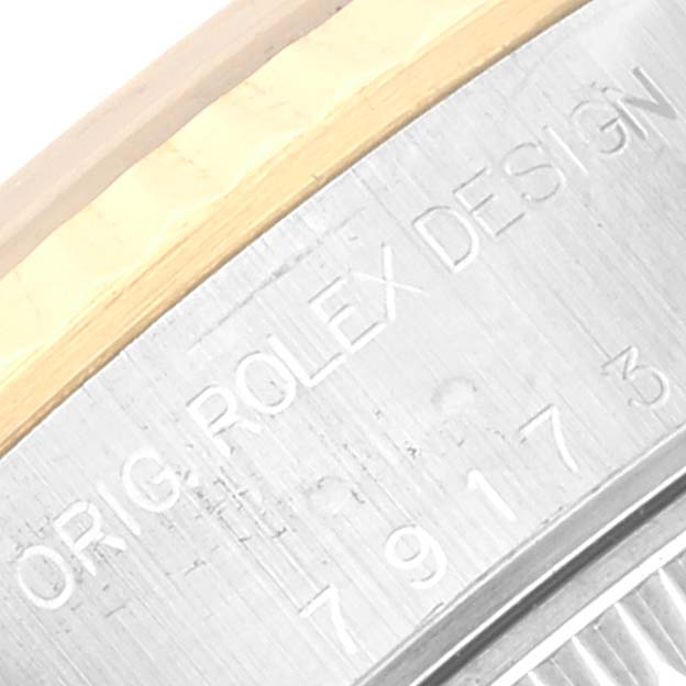 The image shows a close-up of the engraving on the case of a Rolex Datejust 79173 Women's Steel and Gold (two tone) Blue Dial 79173 Women's Steel and Gold (two tone) Blue Dial watch.