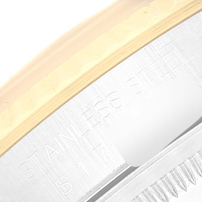 The image shows a close-up of the side of a Rolex Datejust 16233 Men's Steel and Gold (two tone) Champagne Dial 16233 Men's Steel and Gold (two tone) Champagne Dial, focusing on the stainless steel case and part of the fluted bezel.