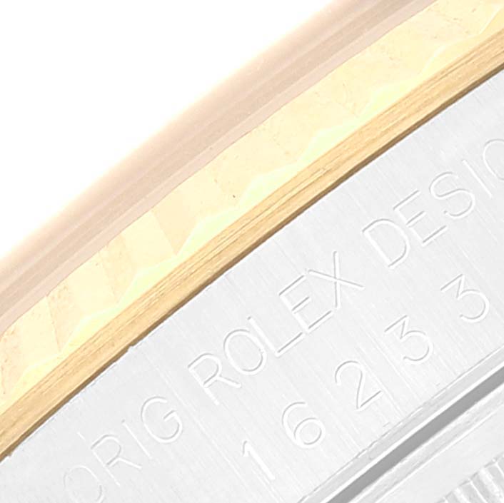 The image shows a close-up of the bezel and engraved edge of a Rolex Datejust 16233 Men's Steel and Gold (two tone) Champagne Dial 16233 Men's Steel and Gold (two tone) Champagne Dial watch.