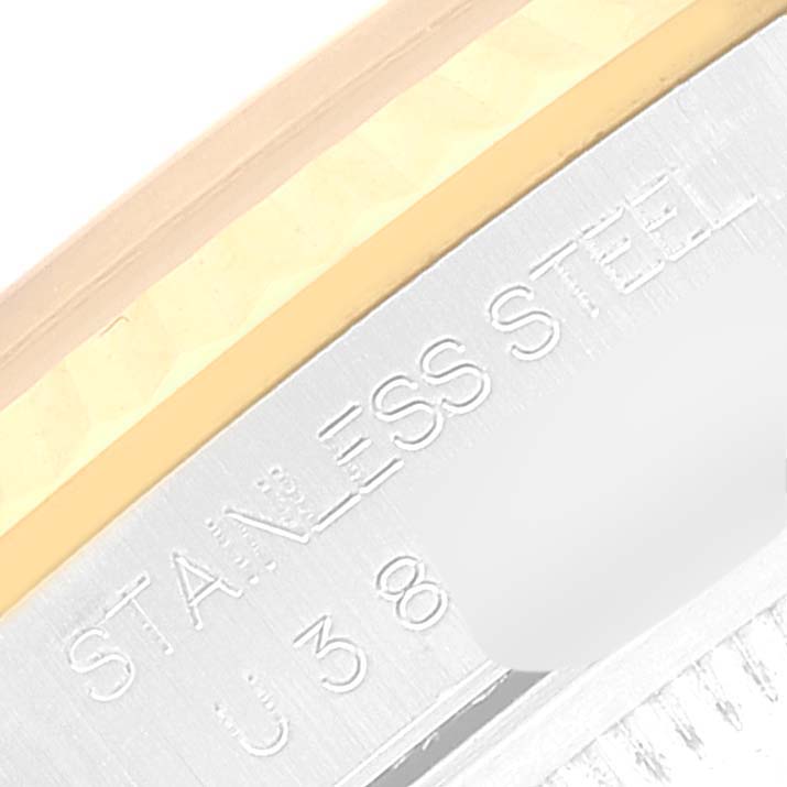 The image shows a close-up of the stainless steel and gold parts of a Rolex Datejust 16233 Men's Steel and Gold (two tone) Champagne Dial 16233 Men's Steel and Gold (two tone) Champagne Dial watch, including engraved lettering.