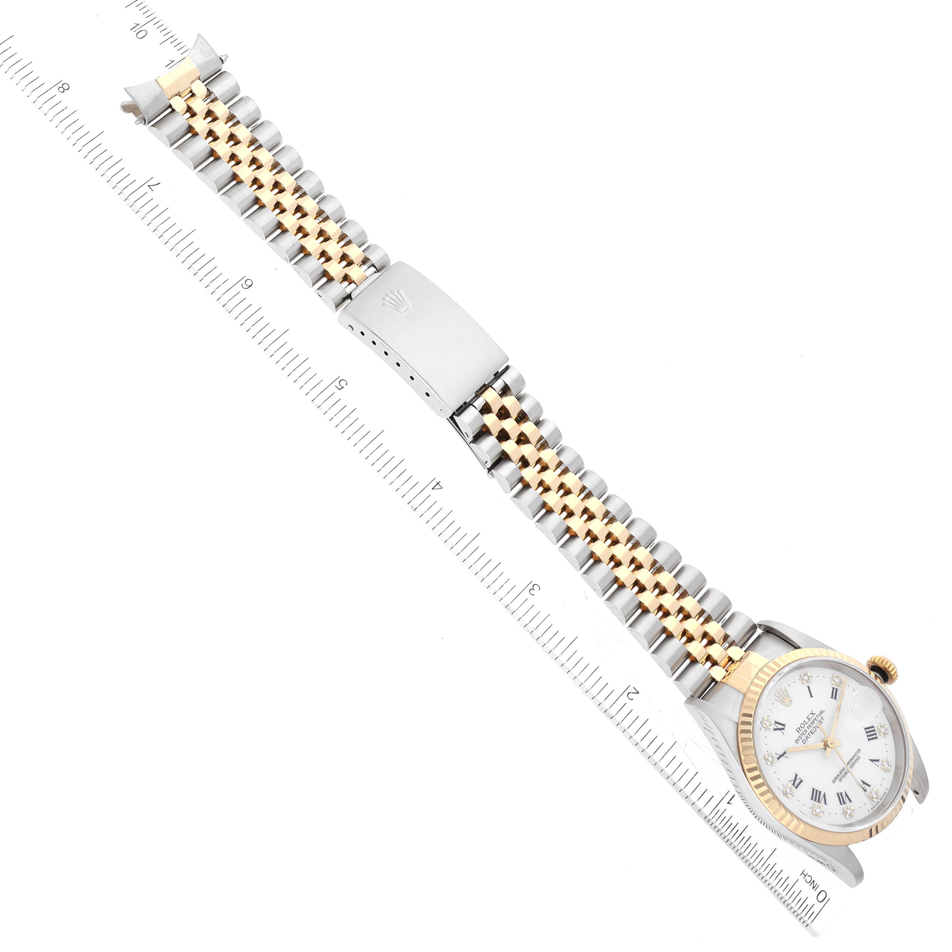 The image shows a Rolex Datejust 16233 Men's Steel and Gold (two tone) White Dial 16233 Men's Steel and Gold (two tone) White Dial watch displayed horizontally with its face, bezel, bracelet, and clasp visible, alongside a measuring ruler.