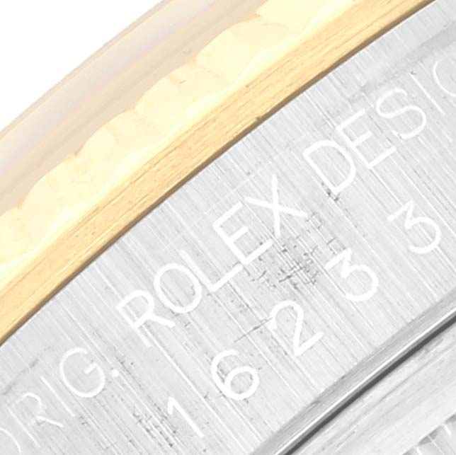 This close-up shows the engraved text on the side of the bezel of a Rolex Datejust 16233 Men's Steel and Gold (two tone) White Dial 16233 Men's Steel and Gold (two tone) White Dial watch.